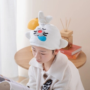 Close-up of white microfiber hair drying towel with cute cartoon animal embroidery