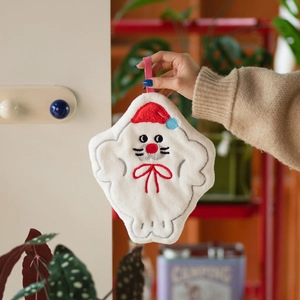 Detail of Christmas themed white plush hand towel with soft coral fleece texture