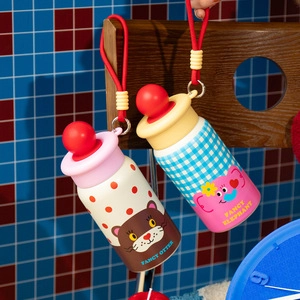Detail of portable water bottles with cartoon animal prints and red spherical caps