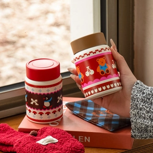 Detailed view of mushroom and bear patterned insulated food jars with heat protection