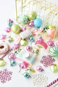 Macro view of macaron-colored Christmas ornaments with glitter and pearl finish
