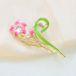 Elegant gold metal flower hair claw with pink petals, white pearls and green leaf detail