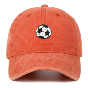 Detailed view of white and black soccer embroidery on orange washed cotton baseball cap