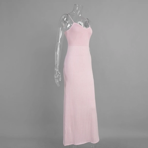 Detailed view of pink knitted ribbed fabric texture and fine straps on maxi dress