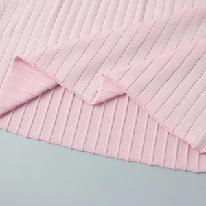Detailed close-up of pink ribbed knit fabric showing soft texture and high elasticity