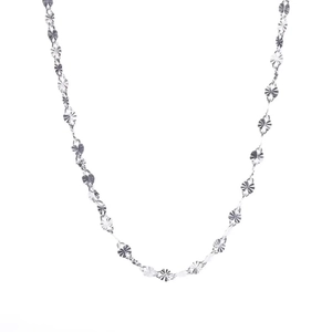 Macro shot of s925 sterling silver chain with textured star cutouts for sparkling effect