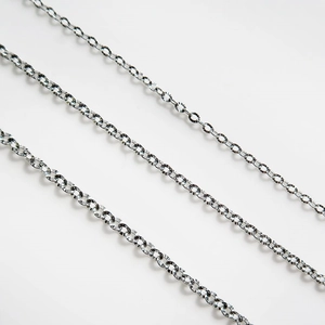 Macro shot of silver S925 sterling silver chain necklaces with diamond-cut texture details
