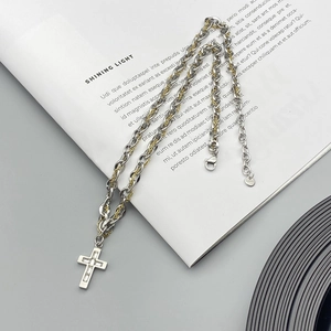 Cross pendant necklace in gold and silver steel links with sparkling zircon inlay