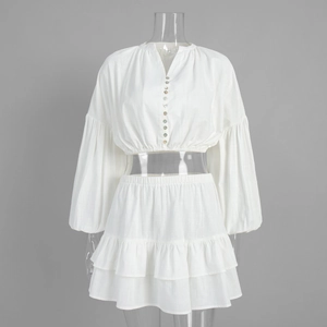 Detail of white cotton set with lantern sleeves and tiered ruffle skirt fabric texture