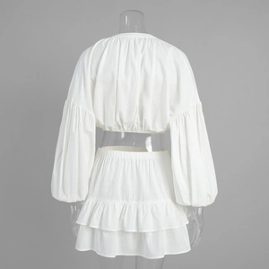 Detail of the back of white cotton two-piece set with lantern sleeves and ruffled skirt