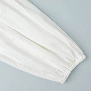 Close-up of elasticated cuff detail on white cotton lantern sleeve summer top