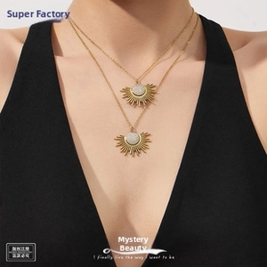 Detailed close-up of 18k gold plated wheat pattern earrings on an Asian model