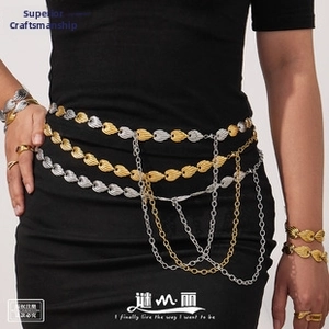 Detail of layered gold and silver leaf belt chain with cascading metal tassels