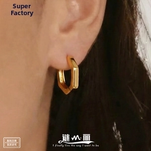 Close-up of a model wearing minimalist 18k gold plated hexagonal hoop earrings