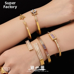 Close-up of 18K gold plated titanium steel bracelets with crystals on a female wrist
