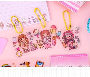 Detailed view of three cartoon acrylic pendants with yellow bead chains for DIY projects