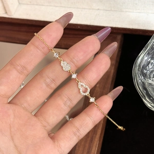 Elegant gold-tone gourd bracelet with shimmering zircon stones on a fine link chain