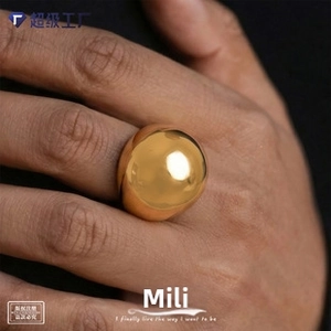 Close-up of a polished gold dome ring showing its glossy mirror finish and chunky style
