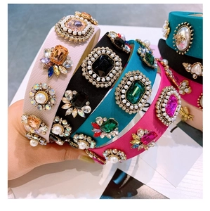 Detail of baroque crystal headbands with colorful gemstones, pearls, and bee accents