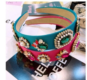 Detailed macro of baroque crystal headbands with emerald and ruby gemstones and pearls