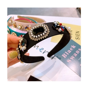 Detail of baroque headband featuring black gemstones, pearls, and crystal flower clusters