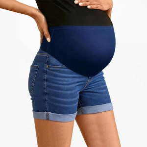 Detail of pregnancy denim shorts showing elastic belly support and rolled-up cuffs