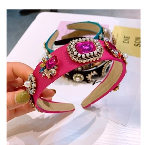 Detailed macro view of baroque headband featuring pink crystals and faux pearls