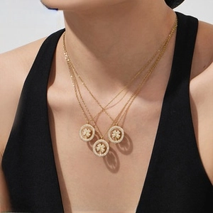 Detailed view of layered 18k gold plated clover necklaces with zircon pavé setting