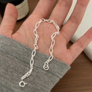 Minimalist S925 sterling silver geometric chain bracelet held in a hand