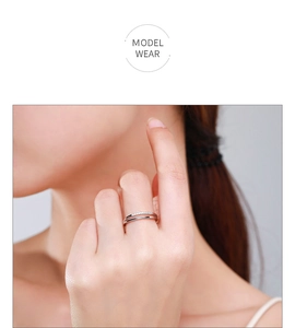 Close-up of double-layered silver ring with pavé-set stones worn by a model