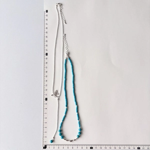 Detailed size measurement of a double-layered butterfly pendant necklace with blue beads