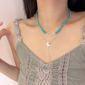 Double-layered blue turquoise beaded necklace with a butterfly pendant and tassel for women