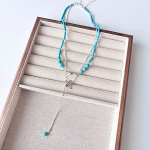 Double-layered blue turquoise beaded necklace with butterfly pendant and long tassel