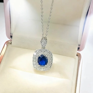 Royal blue sapphire necklace with double halo diamond pendant in a jewelry gift box