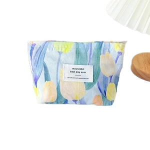 Floral canvas makeup bag with tulip print and zipper closure for cosmetics storage