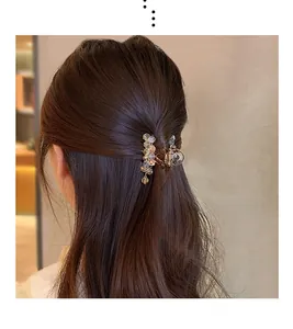 Detailed view of elegant crystal hair claw clip worn on long brunette hair style