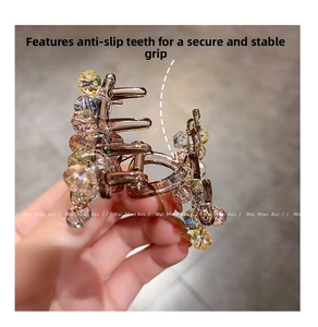 Detail of colorful crystal hair claw clip with anti-slip teeth and metal spring
