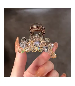 Detailed close-up of handmade crystal beaded hair claw clip with colorful rhinestones