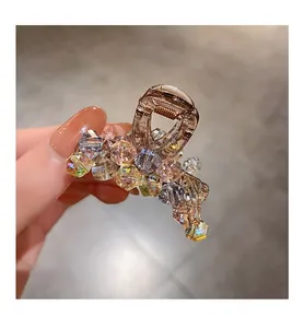 Detail of colorful crystal beaded hair claw clip with golden metal spring and AB finish