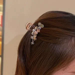 Macaron crystal hair claw clip with colorful faceted beads on dark hair for women