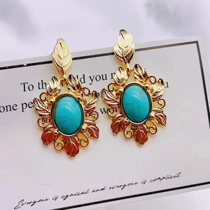 Vintage gold leaf drop earrings with oval turquoise stone on artistic card