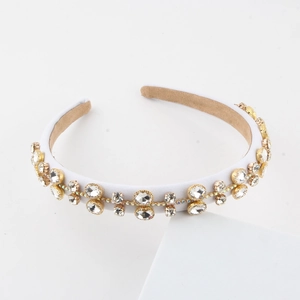 Detail of baroque headband with white satin, rhinestones and sequins on white base