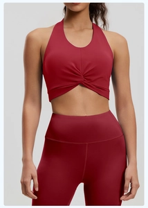Detailed shot of red high-stretch sports bra with knot design and yoga leggings set