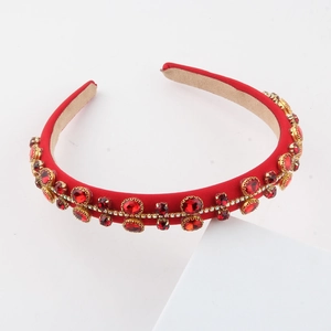 Detailed close-up of Baroque red fabric headband with pearls and rhinestones on white block