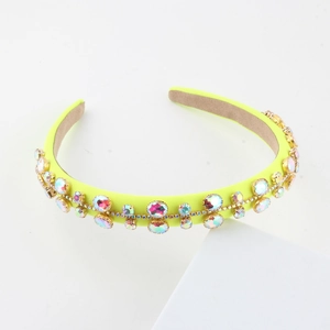 Baroque style yellow fabric headband with colorful rhinestones on geometric display stand