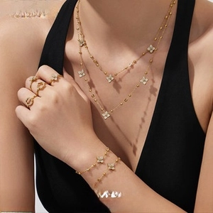 Detailed view of 18k gold plated four-leaf clover jewelry set with zircon crystals