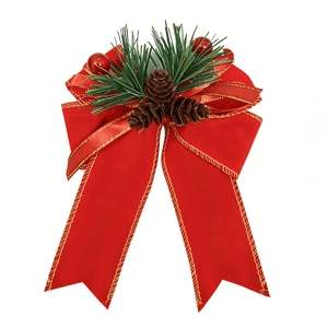 Detail of red satin Christmas bow with gold edges, pine needles, and small pine cones