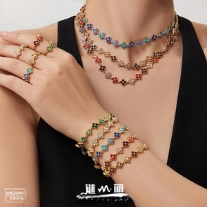 Detail of luxury clover jewelry set with colorful crystals and gold-plated finish