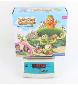 Detail view of Rabbit Traps board game box showing packaging weight on a digital scale