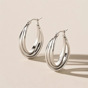 Detailed view of silver triple-layered titanium hoop earrings with high-polish finish